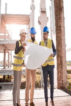 Engineers reviewing plans on a construction site